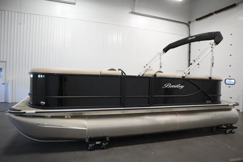 Slide: The Image of 2026 Bentley Pontoons LE 200 CW in showroom, featuring sleek black design and modern amenities. - 7