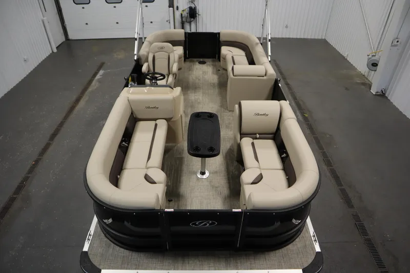 Slide: The Image of 2026 Bentley Pontoons LE 200 CW interior with beige seating and central table. - 8