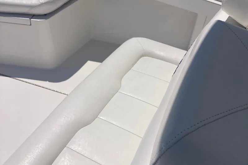 Slide: The Image of 2015 Regulator 23 Forward Seating boat interior with white cushioned seats. - 9