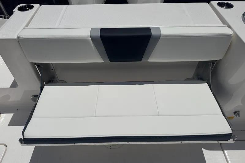 Slide: The Image of Robalo R250 Center Console 2025 boat seat, white with black accent, folded down. - 10