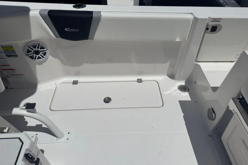 Slide: The Image of 2025 Robalo R250 Center Console boat interior with storage hatch and speaker. - 11