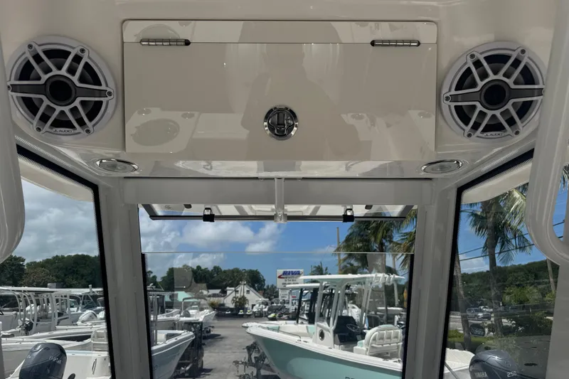 Slide: The Image of 2025 Robalo R250 Center Console interior with speakers and marina view. - 12