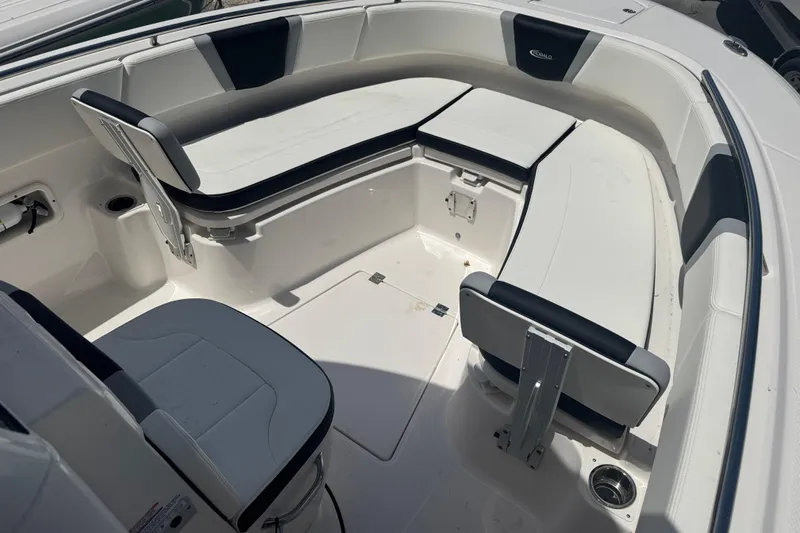 Slide: The Image of 2025 Robalo R250 Center Console boat interior with white seating and storage compartments. - 13