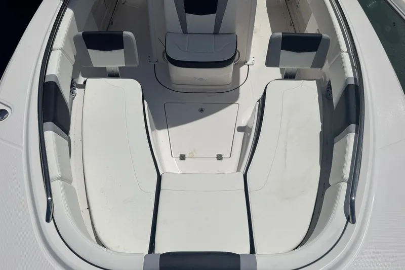 Slide: The Image of 2025 Robalo R250 Center Console boat interior with white seating and storage compartments. - 14