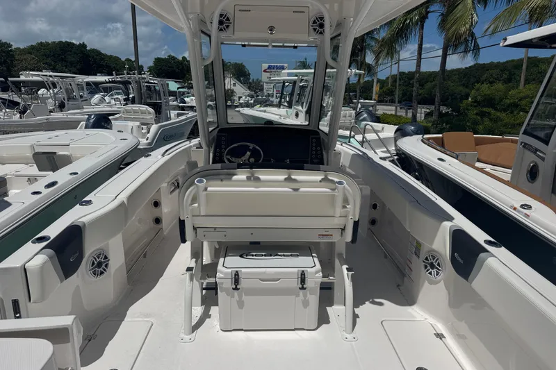 Slide: The Image of 2025 Robalo R250 Center Console boat interior with helm, seating, and storage. - 4