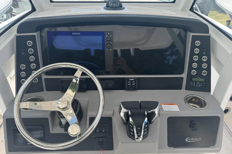 Slide: The Image of 2025 Robalo R250 Center Console dashboard with steering wheel and control panel. - 7