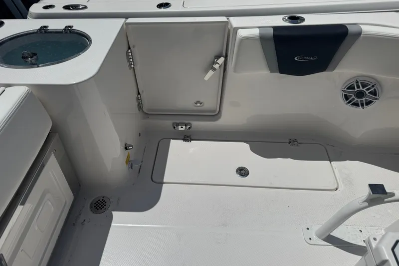 Slide: The Image of 2025 Robalo R250 Center Console boat interior with storage compartments and speaker. - 8