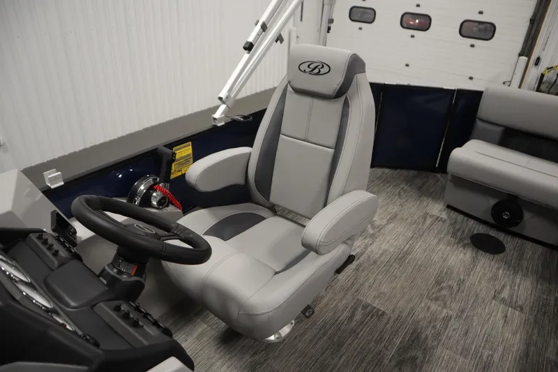 Slide: The Image of 2026 Bentley Pontoons Legacy 200 Cruise XL interior with luxurious captain's chair and steering console. - 25