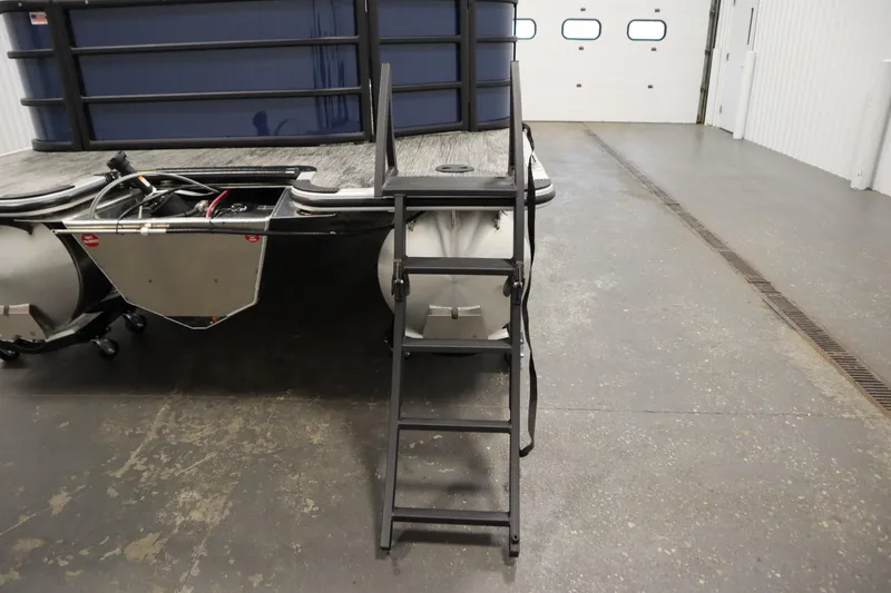 Slide: The Image of 2026 Bentley Pontoons Legacy 200 Cruise XL with rear ladder in a garage setting. - 31