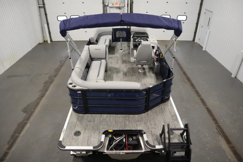 Slide: The Image of 2026 Bentley Pontoons Legacy 200 Cruise XL in a showroom, featuring spacious seating and modern design. - 9