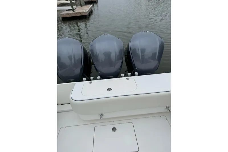 Slide: The Image of 2008 Contender 36 Fisharound with triple outboard motors, docked on calm water. - 7