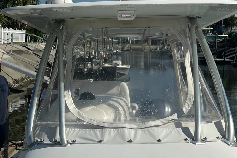 Slide: The Image of 2008 Contender 36 Fish Around boat docked with clear enclosure. - 8