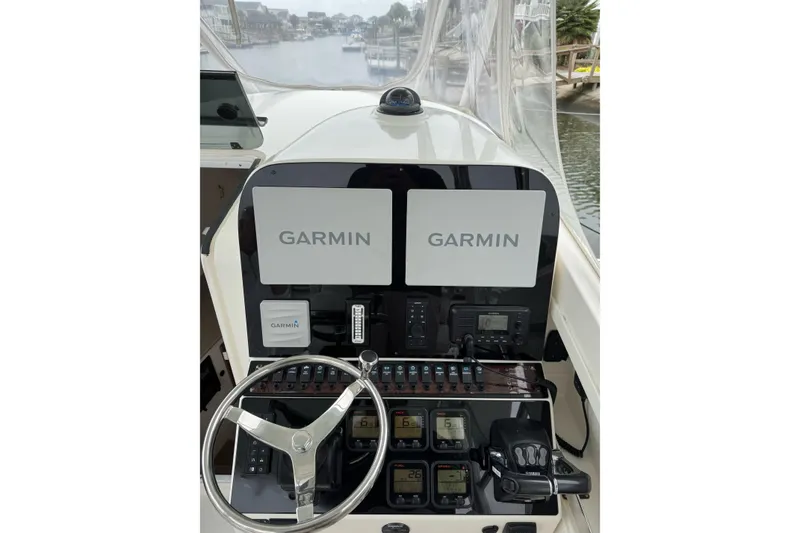 Slide: The Image of 2008 Contender 36 Fisharound helm with dual Garmin displays and navigation controls. - 9