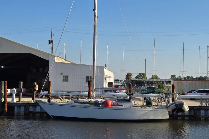 The Image of 1981 Morgan 321 sailboat docked at marina with clear blue sky. - 0