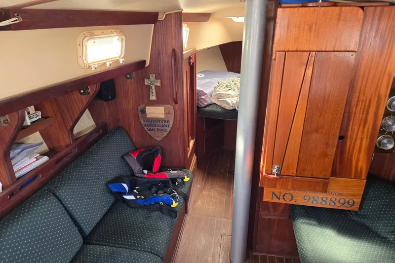 Slide: The Image of Interior of a 1981 Morgan 321 sailboat with wooden furnishings and seating. - 4