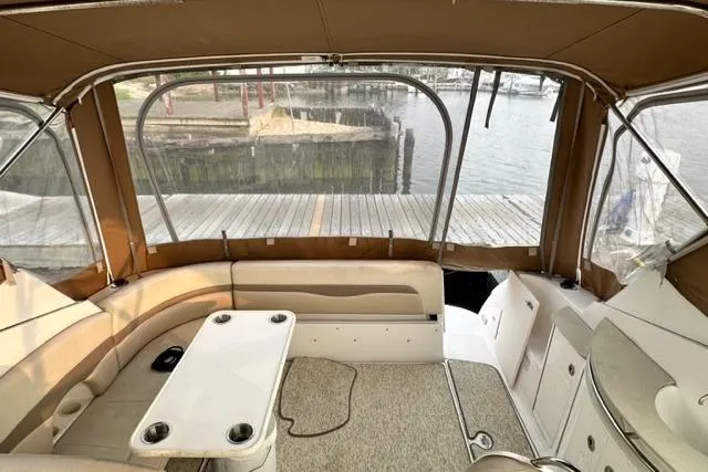 Slide: The Image of 2004 Chaparral Signature 350 boat interior with seating and table, dockside view. - 10