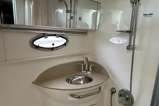 Slide: The Image of 2004 Chaparral Signature 350 bathroom with sink, mirror, and showerhead. - 11