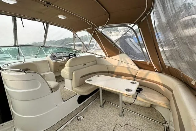Slide: The Image of 2004 Chaparral Signature 350 boat interior with seating and table under canopy. - 14