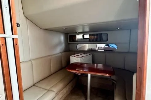 Slide: The Image of 2004 Chaparral Signature 350 interior with beige seating and wooden table. - 15