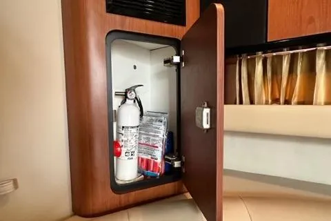 Slide: The Image of Open cabinet in 2004 Chaparral Signature 350 with fire extinguisher and supplies. - 18