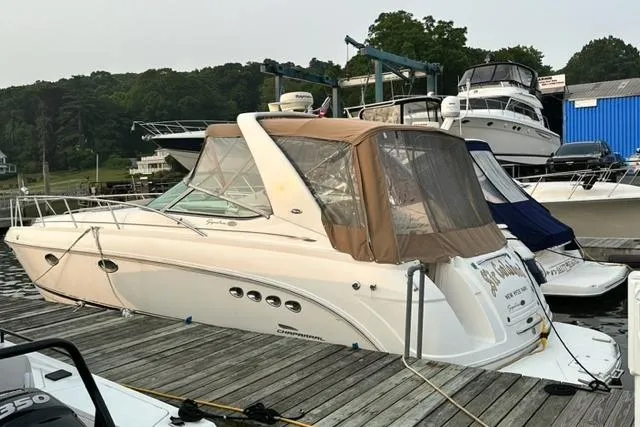 Slide: The Image of 2004 Chaparral Signature 350 boat docked at marina with brown canopy. - 2