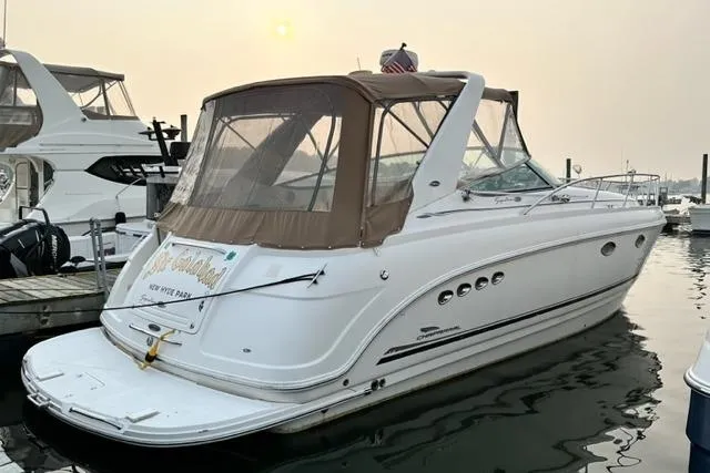 Slide: The Image of 2004 Chaparral Signature 350 boat docked at marina under a hazy sky. - 4
