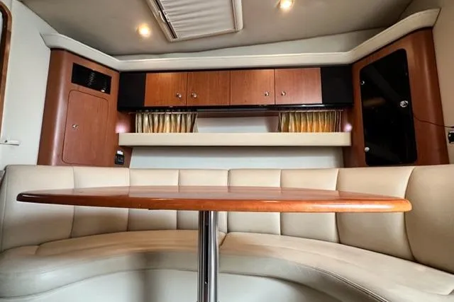 Slide: The Image of 2004 Chaparral Signature 350 interior with curved seating and wooden cabinetry. - 7