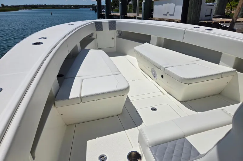 Slide: The Image of 2016 SeaVee 390Z boat interior with white cushioned seating and spacious deck. - 10