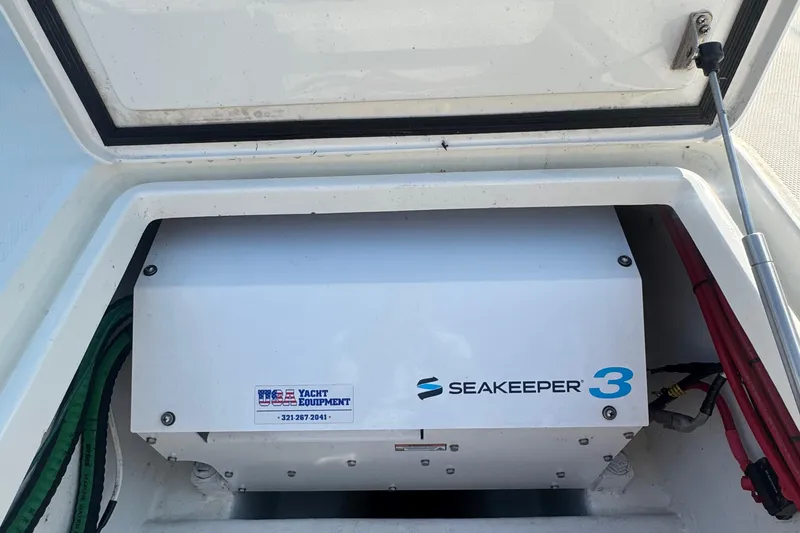 Slide: The Image of 2016 SeaVee 390Z boat docked by a wooden pier on a sunny day. - 12