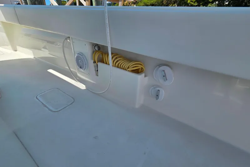 Slide: The Image of 2016 SeaVee 390Z boat interior, featuring white seating and deck details. - 15