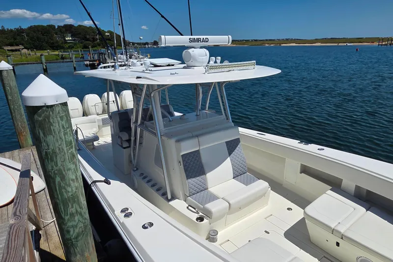 Slide: The Image of 2016 SeaVee 390Z boat docked, featuring a sleek design and spacious seating. - 3