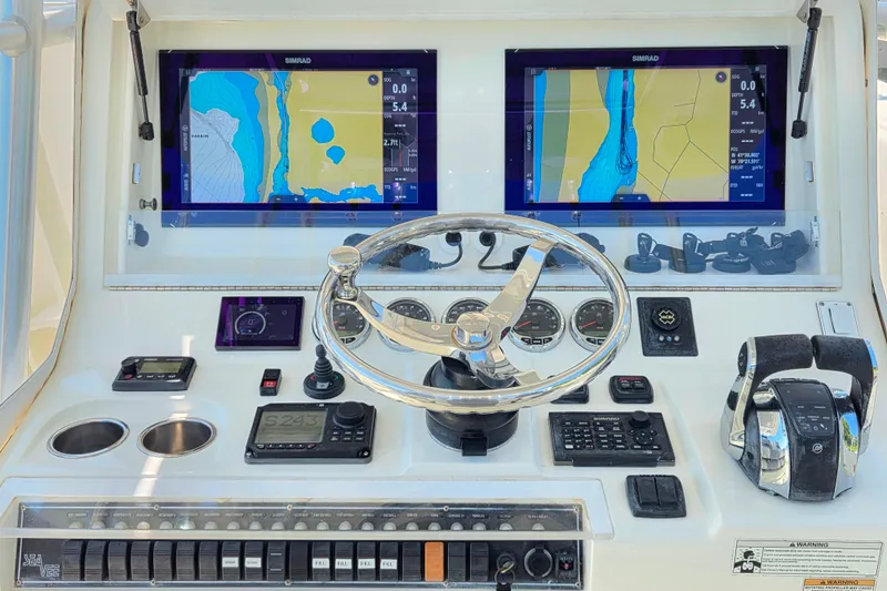 Slide: The Image of 2016 SeaVee 390Z helm with dual Simrad displays and advanced navigation controls. - 6