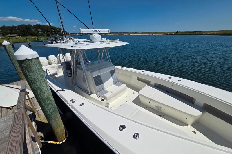 Slide: The Image of 2016 SeaVee 390Z boat docked in a serene marina setting. - 7