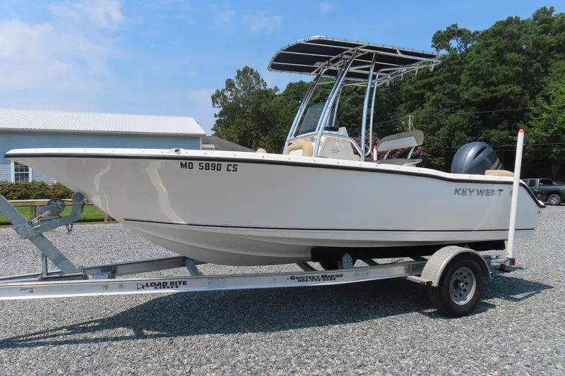 Slide: The Image of 2017 Key West 203 FS boat on trailer, parked outdoors on gravel. - 0