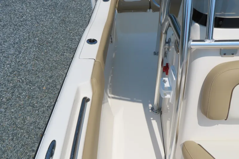 Slide: The Image of 2017 Key West 203 FS boat interior with beige seating and stainless steel railings. - 15