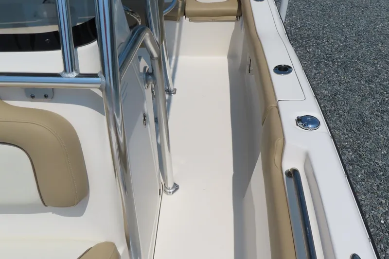 Slide: The Image of 2017 Key West 203 FS boat interior with beige seating and stainless steel railings. - 16