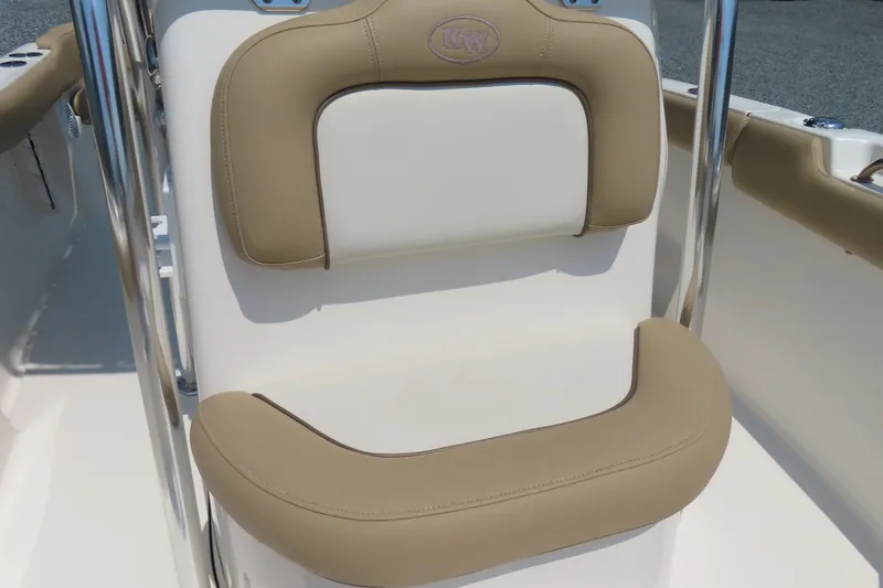 Slide: The Image of 2017 Key West 203 FS boat seat with beige and white cushioned design. - 17