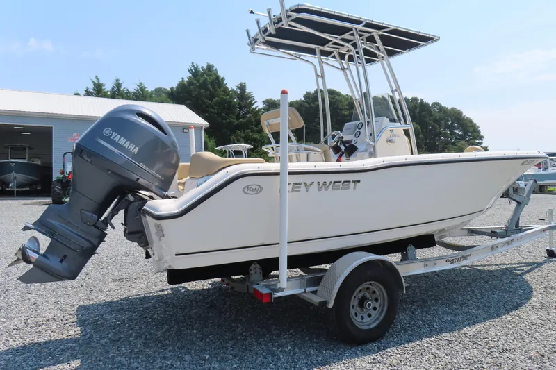 Slide: The Image of 2017 Key West 203 FS boat on trailer with Yamaha outboard motor, parked outdoors. - 2