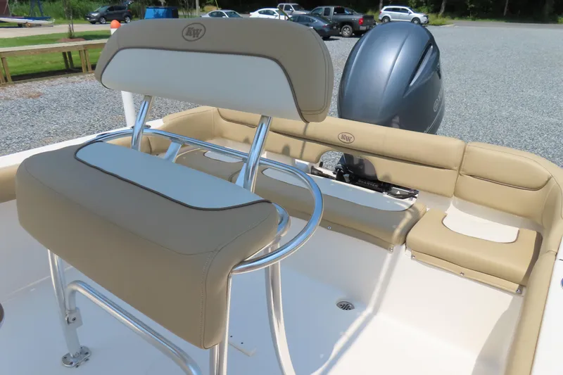 Slide: The Image of 2017 Key West 203 FS boat interior with beige seating and outboard motor. - 21