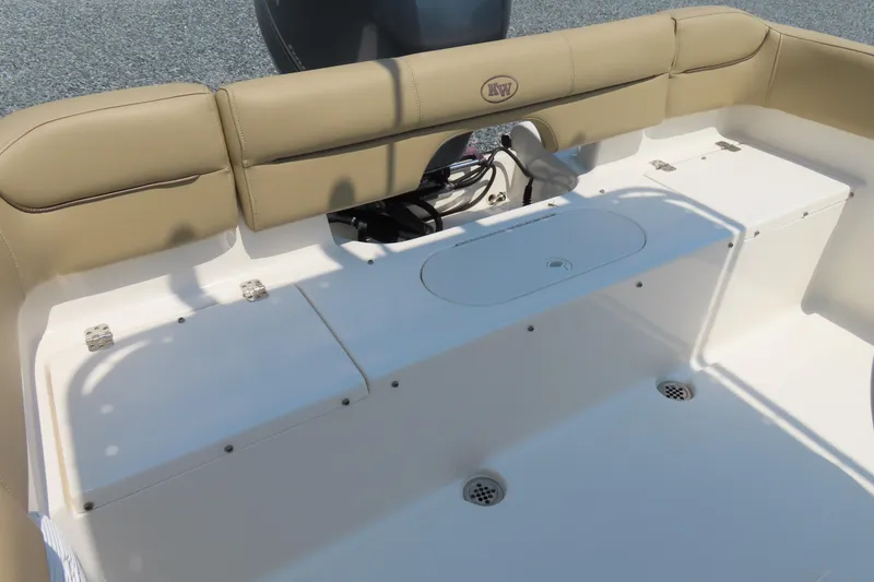 Slide: The Image of 2017 Key West 203 FS boat interior with tan seating and storage compartments. - 26