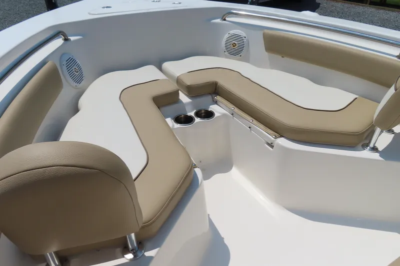 Slide: The Image of 2017 Key West 203 FS boat interior with beige seating and cup holders. - 7