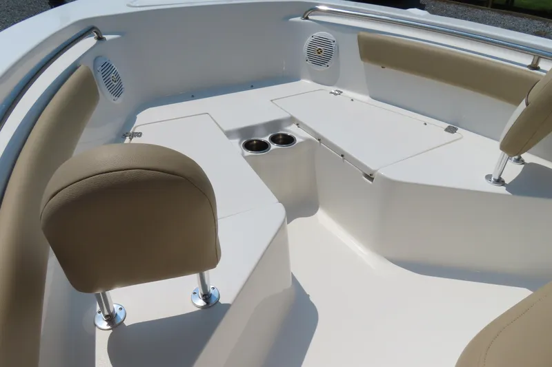 Slide: The Image of 2017 Key West 203 FS boat interior with beige seating and cup holders. - 8