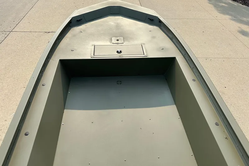 Slide: The Image of 2026 Tracker Grizzly 1754 Utility boat interior, showcasing spacious deck and storage compartment. - 3