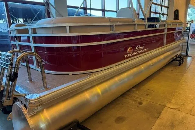 The Image of 2025 Sun Tracker Party Barge 24 DLX pontoon boat displayed indoors. - 0