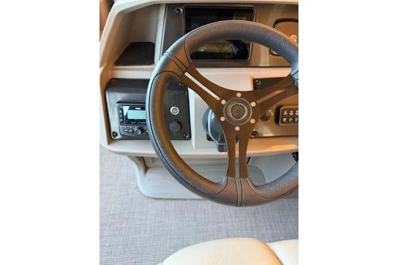 Slide: The Image of Steering wheel of 2025 Sun Tracker Party Barge 24 DLX pontoon boat. - 13