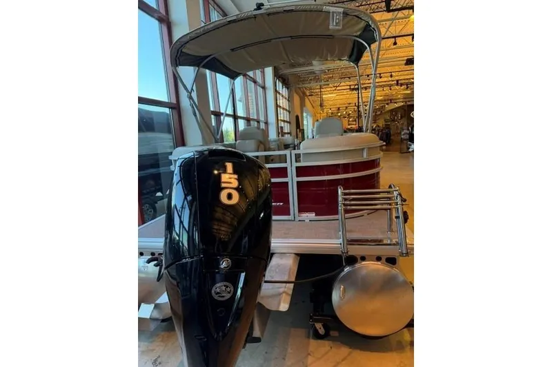 Slide: The Image of 2025 Sun Tracker Party Barge 24 DLX pontoon boat with 150 HP engine in showroom. - 4