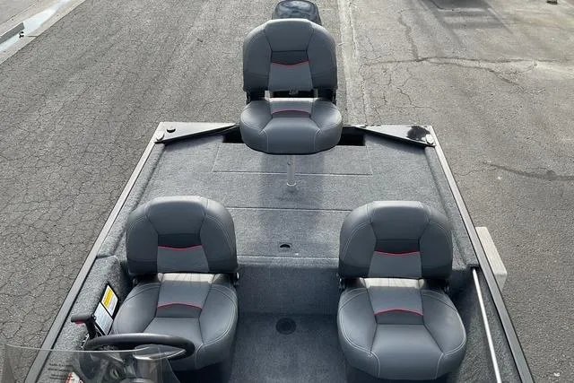 Slide: The Image of 2026 Tracker Bass Tracker Classic XL boat with three gray seats on deck. - 12