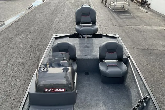 Slide: The Image of 2026 Tracker Bass Tracker Classic XL boat with four seats on a paved surface. - 13
