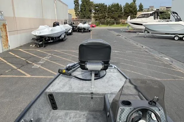 Slide: The Image of 2026 Tracker Bass Tracker Classic XL boat in a parking lot with other boats. - 14