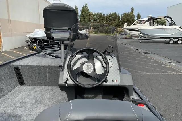 Slide: The Image of 2026 Tracker Bass Tracker Classic XL boat interior with steering wheel and seating. - 15
